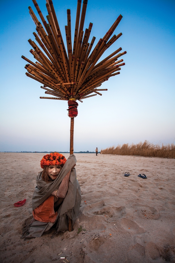 Jagmohan Giri holding a flute seller's stand. 